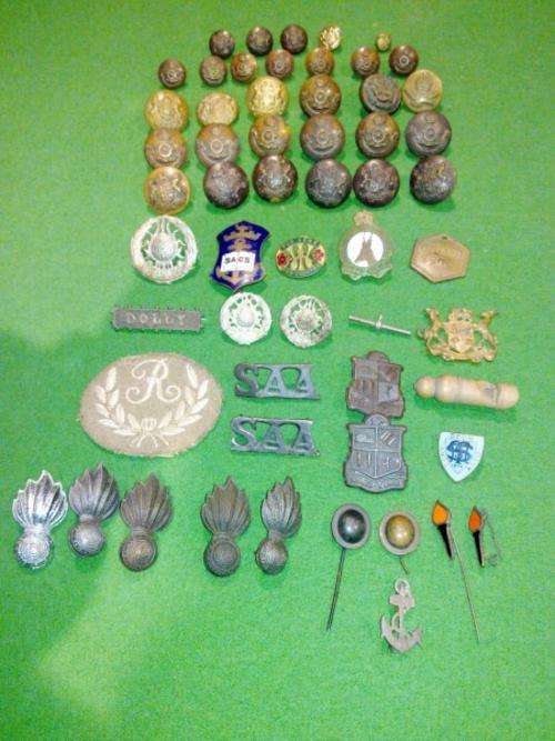 A collection of 57 military badges, buttons and insignia - priced to go!